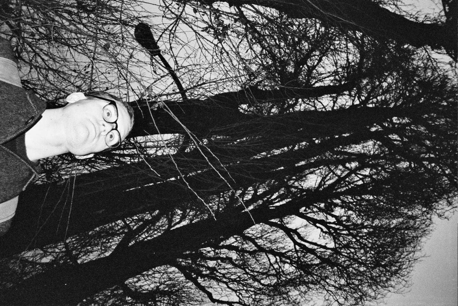 nathan at night under some trees, black and white