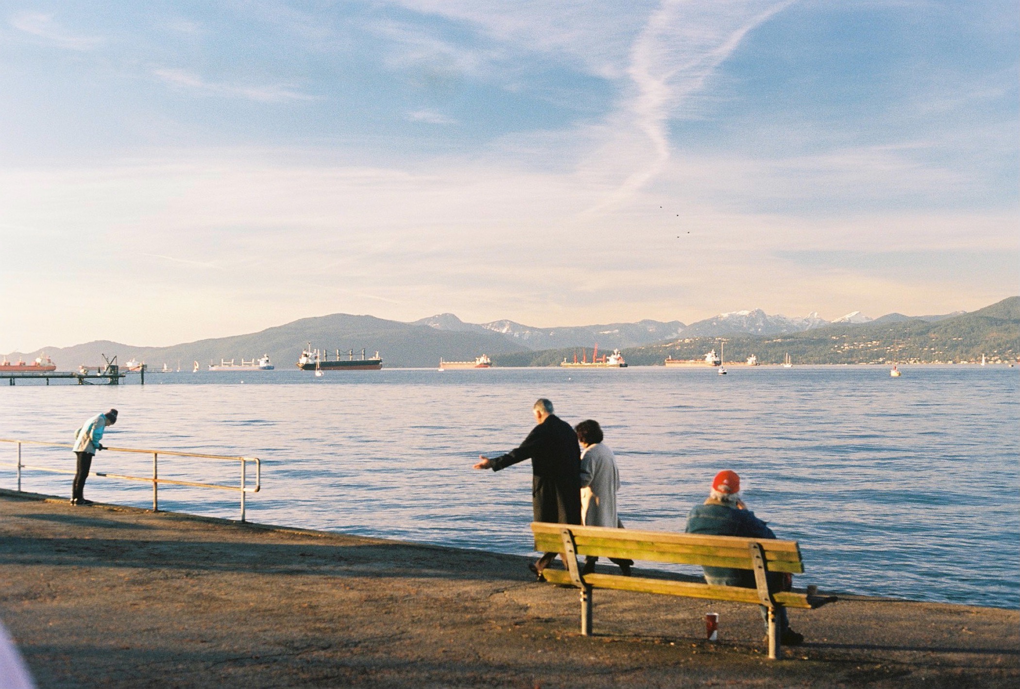 people go for a walk along the kitsilano boardwalk, vancouver