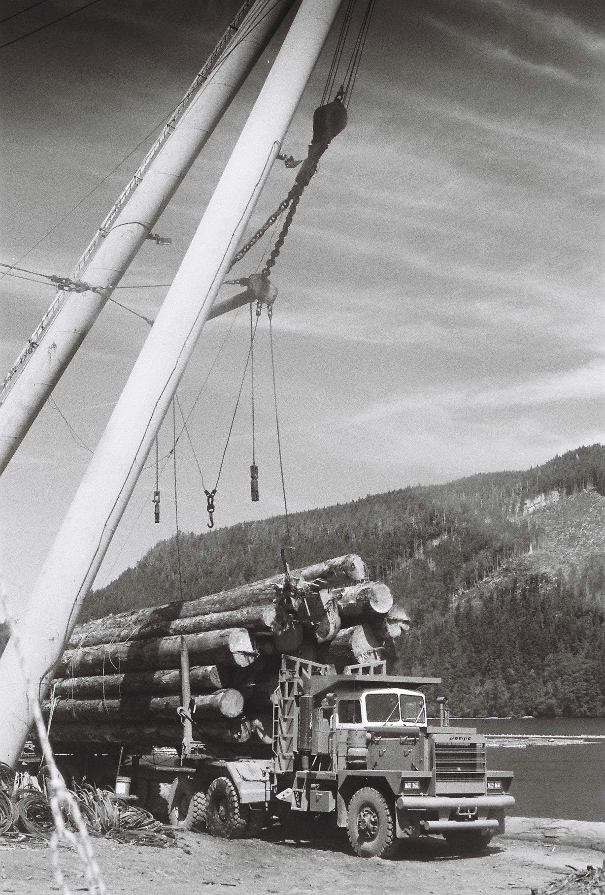 a logging truck is loaded with logs, black and white