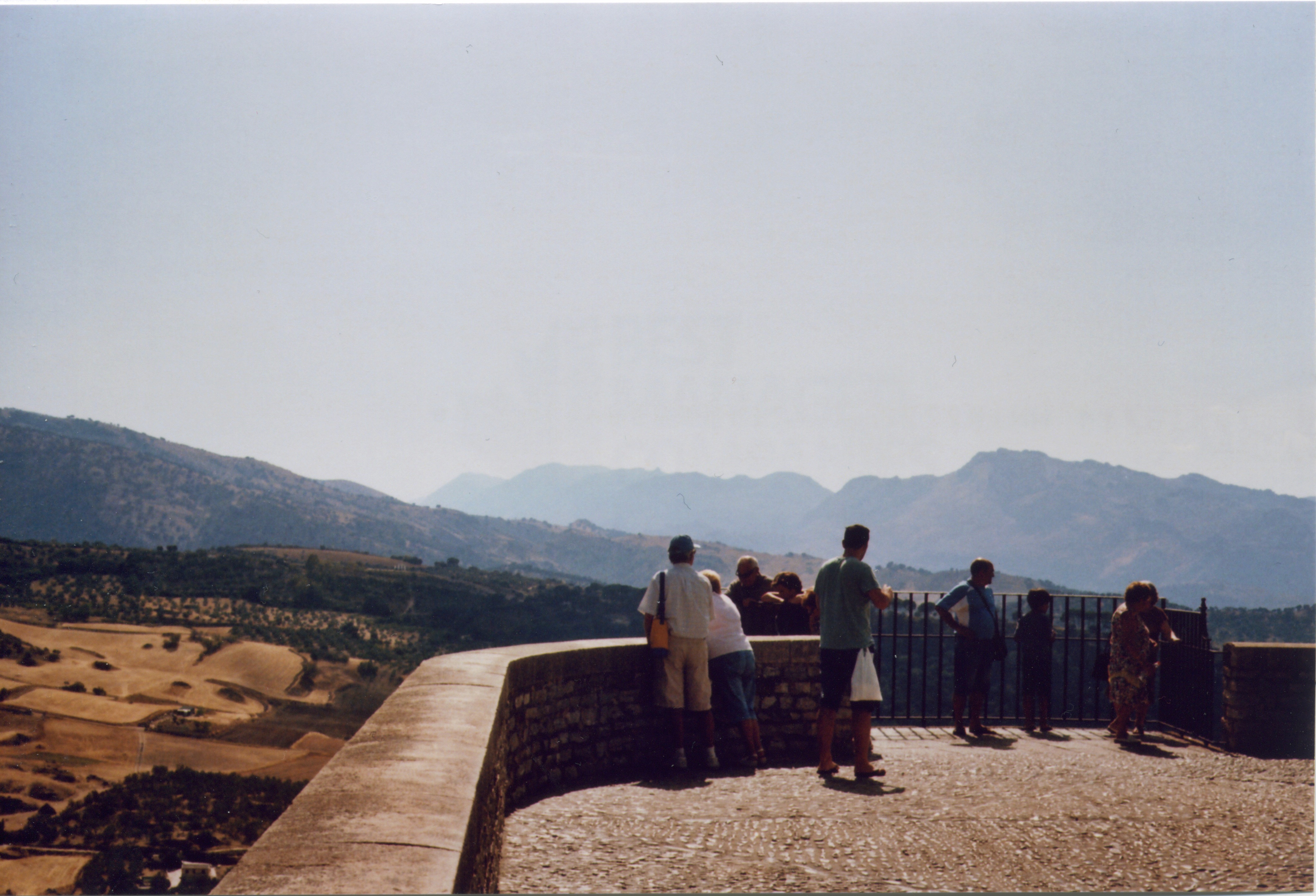 people look out over the countryside in ronda, spain