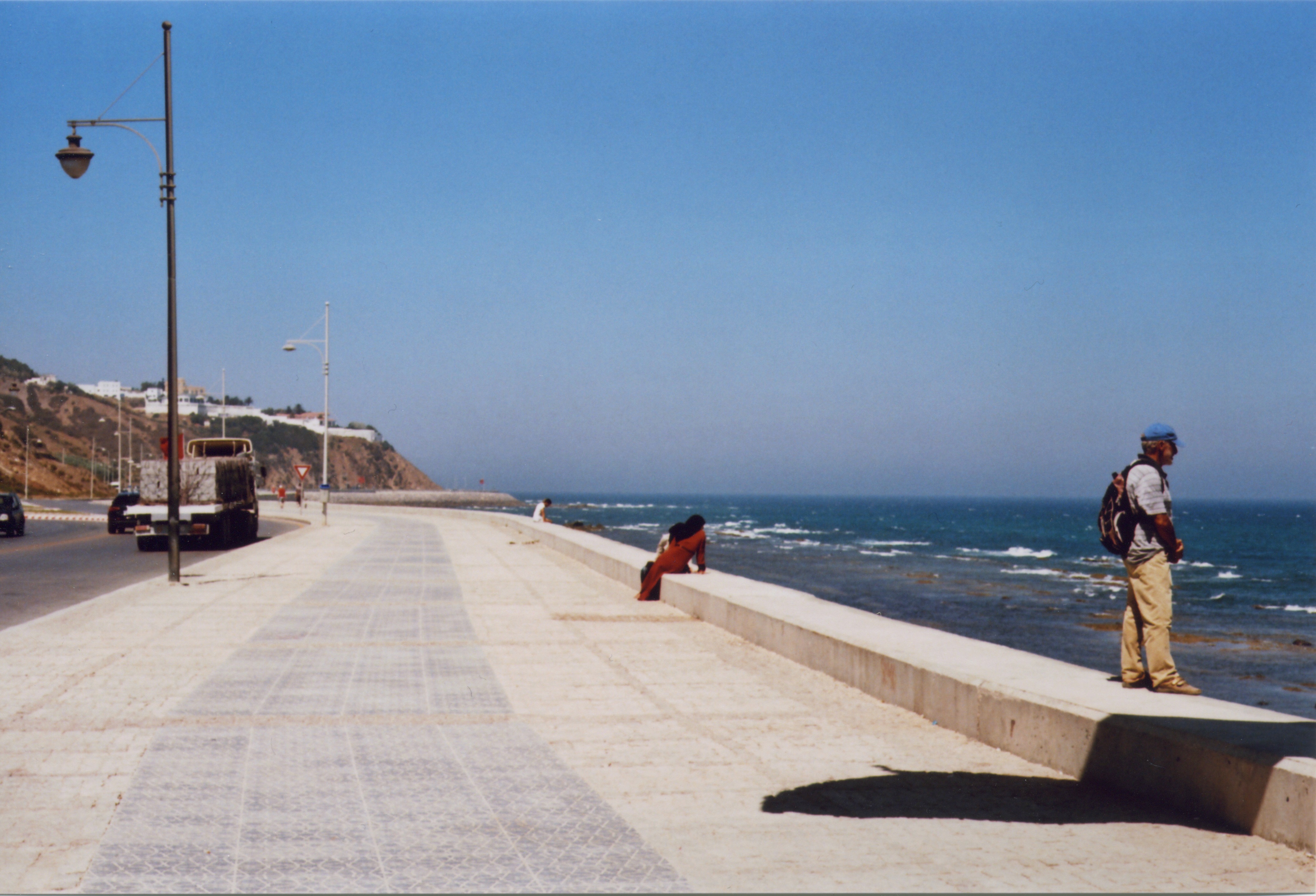 people stand to look out over the water in tangiers, morocco