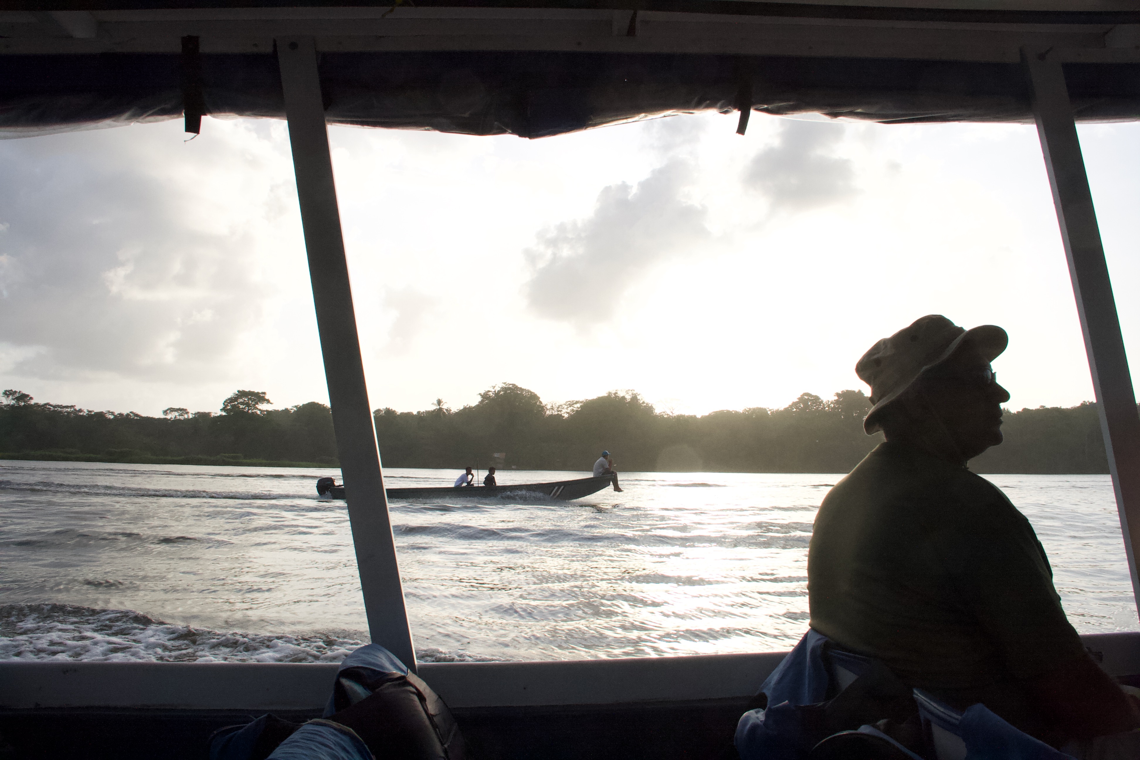 people sitting in a boat travel fast, tortuguero, costa rica